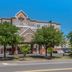 Comfort Inn & Suites Virginia Beach - Norfolk Airport exterior in Virginia Beach with trees and blue sky