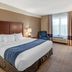Comfort Inn & Suites Virginia Beach - Norfolk Airport guest room with king bed and window seat