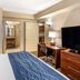 Comfort Inn & Suites Virginia Beach - Norfolk Airport room with bed, desk, chair, dresser and large TV