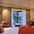 Claires of Sandton Luxury Guest House room with sliding doors to a patio and work desk