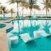 Margaritaville Island Reserve Riviera Cancun pool with palm trees and ocean view in Puerto Morelos
