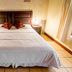 La Ermita de Santa Lucia in Antigua, simple guest room with double bed, bedside lamps, and tiled floor