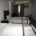 Big Hotel Suites Mandaue City room with two twin beds, curtains, desk and air conditioner