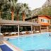 Canada Hotel & Bungalows in Cirali with outdoor pool, loungers, and mountain backdrop