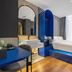 Yiting Huicheng Hotel Xiamen guest room with blue platform bed, arched mirror and desk