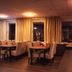 Liljeholmens Stadshotell in Stockholm dining room with set tables, beige chairs, and warm evening lighting