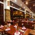 Tianfuyuan Resort Sanya restaurant with wooden tables, pendant lighting and tiled floors