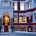 Althoff St James's Hotel & Club London exterior with ornate entrance and glowing windows in London