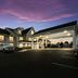 Red Roof Inn & Suites Knoxville East exterior with covered entrance at dusk in Knoxville