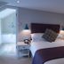 The Carpenters Arms, Bristol: compact guest room with bed, bedside lamps and en suite bathroom door