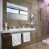 Hotel Del Sole Pompei bathroom with double sink, glass shower and robe