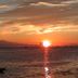 Lazy Dog Bed & Breakfast in Boracay with sunset over the ocean and a small boat silhouette
