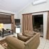 Anew Resort White River Mbombela living room with sofa, TV, table lamp and patio doorway to outdoor seating