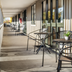 Tasman Holiday Parks - Christchurch corridor with outdoor tables and chairs beside glass windows
