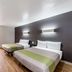 Studio 6-San Antonio, TX - Fort Sam Houston Area room with two beds and wood-look flooring