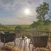 Four Seasons Safari Lodge Serengeti deck with seating and sunset view over the Serengeti