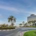 Hyatt Regency Galleria Residence Dubai in Dubai with curved towers, palm trees, and a landscaped roundabout