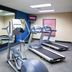 Hampton Inn & Suites Lake Wales fitness room with treadmills, elliptical, mirror and exercise ball