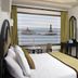 Hotel Sea View in Kanyakumari room with large window overlooking the sea and lighthouse