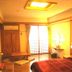 Sin Fu Business Hotel in Taichung City guest room with bed, desk, TV, and sliding glass doors