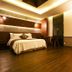 Karak Tourist Hotel in Seoul guest room with king bed, wood flooring, and warm ceiling lighting
