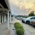 Sea Girt Lodge in Sea Girt exterior walkway with parking lot and vehicles at dusk