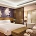 Minyoun Chengdu Dongda Hotel in Chengdu guest room with king bed and floral wall art