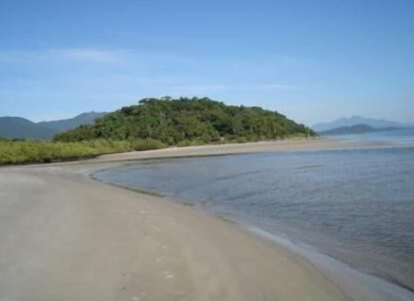 Hotel Recanto do Sol in Cananéia with a sandy beach, calm water, and lush island views