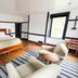 Shaker Village of Pleasant Hill guest room in Harrodsburg with a wood bed, armchairs, and striped rug