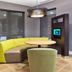 Courtyard by Marriott Houston I-10 West/Memorial lobby seating area with curved lime sofa and round table