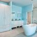 Cane Garden Bay Beach Hotel in Leonards bathroom with freestanding tub and glass shower