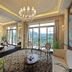 Chateau Star River Beijing dining lounge with chandelier, large windows and river views in Beijing