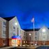 Candlewood Suites Williamsport exterior at dusk with illuminated entrance and flagpole