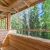 Basecamp Oulanka in Kuusamo: wooden balcony with chair and forest view