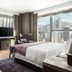 The St. Regis Hong Kong guest room with city skyline views through floor-to-ceiling windows
