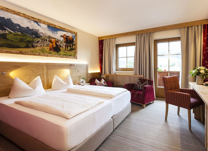 Hotel Kaiser in Tirol in Scheffau am Wilden Kaiser guest room with twin beds, desk, and mountain view windows