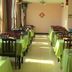 Jia Hao Beijing dining room with green tablecloths and wooden chairs