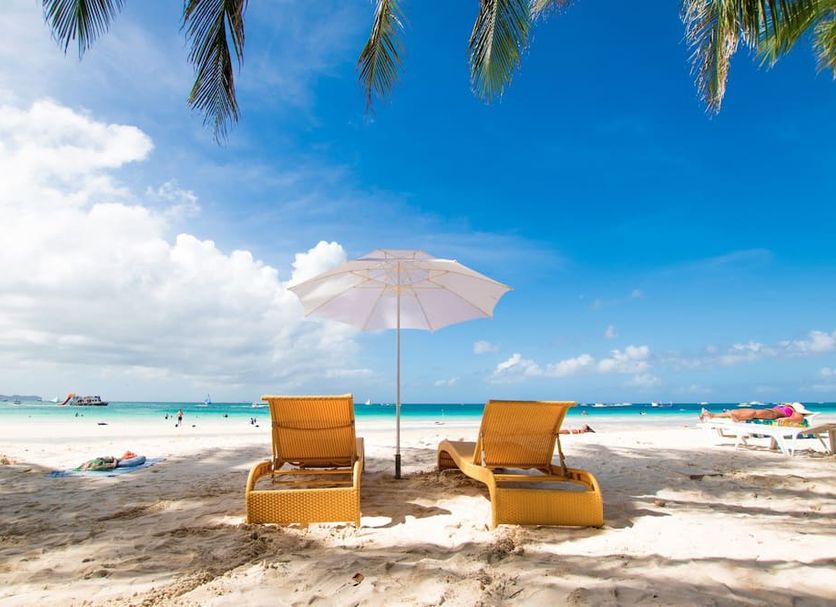 Bamboo Bungalow Resthouse Boracay beach view with two loungers and an umbrella on Boracay sand