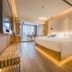 Puruihotel Yongkang in Jinhua: modern hotel room with king bed, warm lighting, and city-view windows