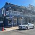 Americas Best Value Inn & Suites Royal Carriage in Jamestown, historic two-story building with balcony and street view