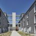 Aparthotel Baden courtyard with modern gray buildings and central glass walkway in Baden