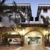 Hotel Villa Varadero in Nuevo Vallarta entrance with stone archway, palm trees, and lit lanterns