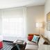 Towneplace Suites By Marriott Danville guest room with king bed, sofa, and large window
