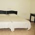 MM Tourist Home in Kāsaragod: simple guest room with two single beds and tiled floor