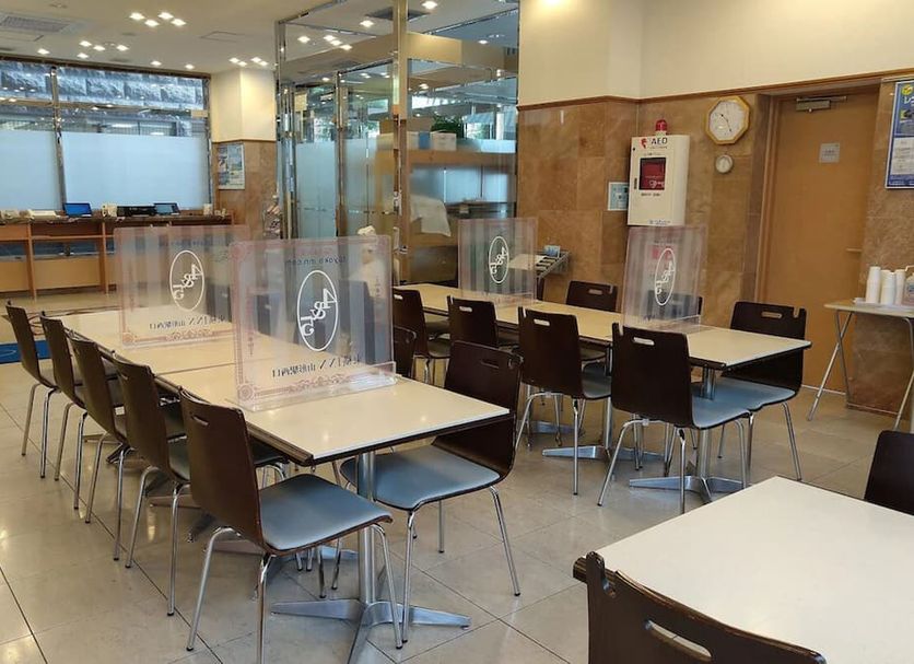 Toyoko Inn Yamagata-eki Nishi-guchi breakfast dining area with tables, chairs, and clear acrylic partitions