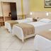 Hotel Steinhausen, Blumenau: triple room with three single beds, beige accents, and tiled floor
