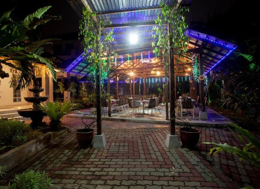 Nighttime courtyard dining area at Hotel Seri Malaysia Johor Bahru with lit pavilion and fountain