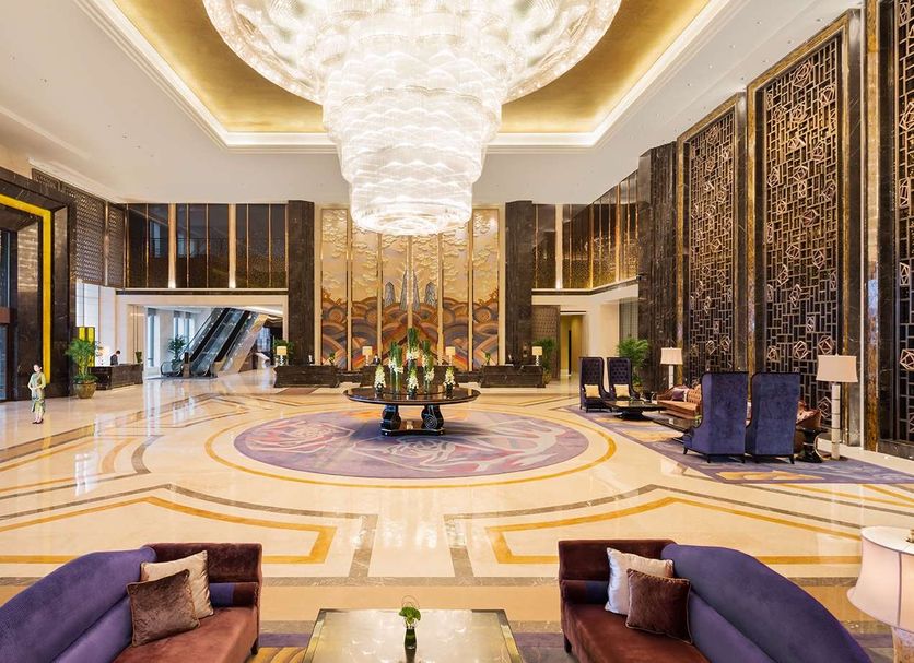 Wanda Realm Fushun lobby with chandelier, marble floor, and seating area in Fushun