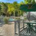 Seahorse Cottages on Sanibel outdoor patio with table, umbrella and poolside view
