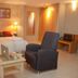 La City Estación Alicante guest room with double bed, armchair, and small table